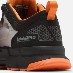 Close up of Timberland PRO Powertrain safety toe men's athletic work sneaker in black and orange showing composite toe stamp with a blank background.