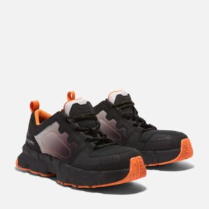 A turned pair of Timberland PRO Powertrain composite toe men's athletic work sneakers in black and orange with a blank background.