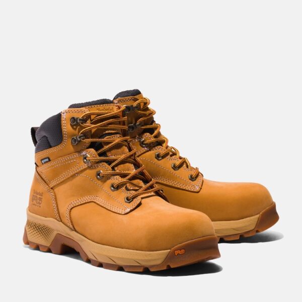 A turned pair of Timberland PRO TiTAN EV composite toe waterproof men's 6-inch work boots in wheat with a blank background.