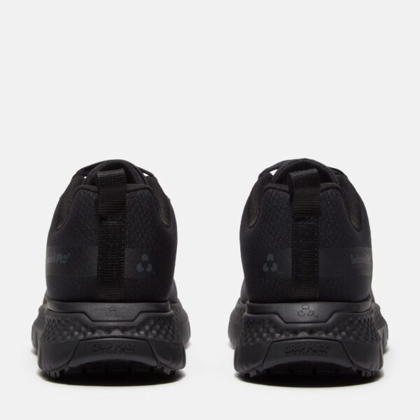 A look at the heels of a pair of Timberland Power Shift soft toe hospitality women's work sneakers in black with a blank background.