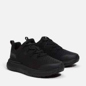 A turned pair of Timberland Power Shift soft toe hospitality women's work sneakers in black with a blank background.