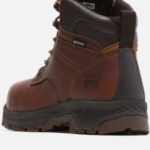 Close up of Timberland TiTAN EV safety toe women's 6-inch work boot in brown showing composite toe stamp and waterproof tag with a blank background.