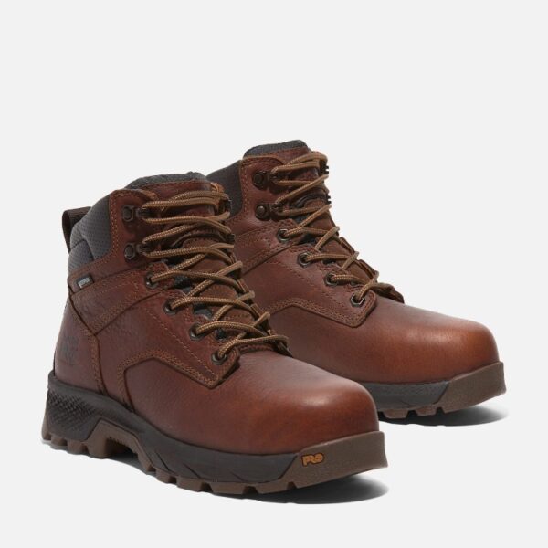 A turned pair of Timberland TiTAN EV composite toe waterproof insulated women's 6-inch work boots in brown with a blank background.