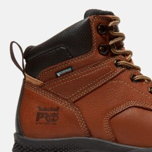 Close up of Timberland TiTAN EV safety toe women's 6-inch waterproof work boot in brown showing composite toe stamp with a blank background.