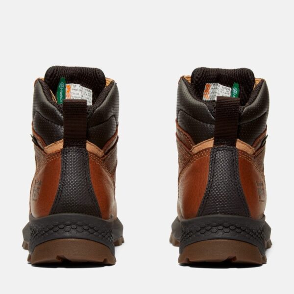 A look at the heels of a pair of Timberland TiTAN EV composite toe waterproof women's 6-inch work boots in brown with a blank background.