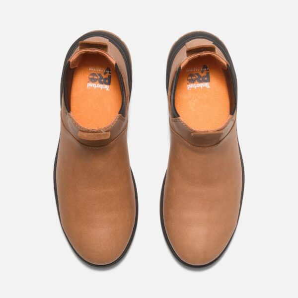 Overhead look at a pair of Timberland PRO Birchline composite toe 6-inch women's pull-on work boots in tan on a blank background.