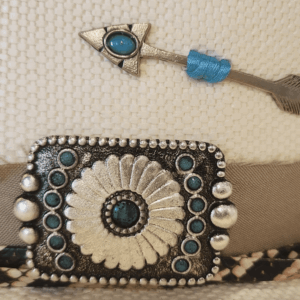 A closeup look at the hatband and concho on a Charlie 1 Horse Spear Point White Straw Fashion Hat.