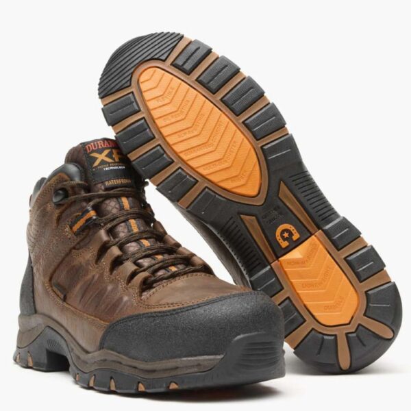 A 3/4 turned pair of Durango Renegade XP Waterproof Timber Brown Alloy Toe Hikers with a look at the sole of the left boot.