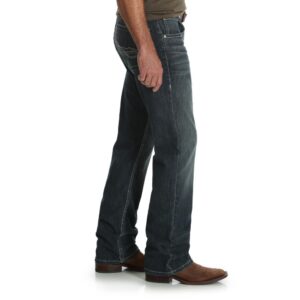 A modeled, right-side-facing look at a pair of Wrangler Men's 20X No. 42 Vintage Bootcut Jeans.
