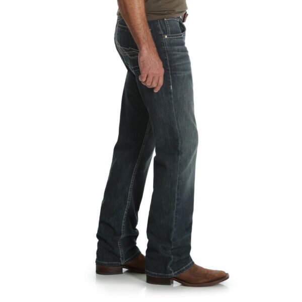 A modeled, right-side-facing look at a pair of Wrangler Men's 20X No. 42 Vintage Bootcut Jeans.