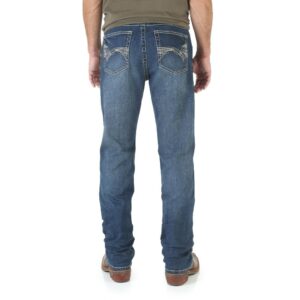A modeled, rear-facing look at a pair of Wrangler Men's 20X No. 42 Vintage Bootcut Jeans.