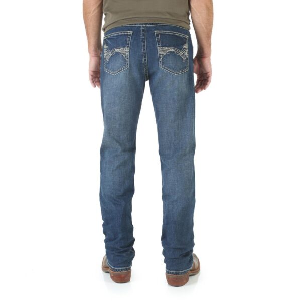 A modeled, rear-facing look at a pair of Wrangler Men's 20X No. 42 Vintage Bootcut Jeans.