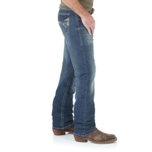 A modeled, right-side-facing look at a pair of Wrangler Men's 20X No. 42 Vintage Bootcut Jeans.