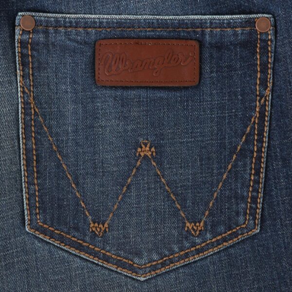 A detailed, closeup look at the stitching and design on a Wrangler Men's Retro Relaxed Fit Bootcut Jean pocket.