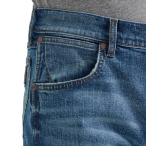 A modeled, close-up look at the detail on the front pocket of a pair of Wrangler Men's Retro Slim Bootcut Jeans.