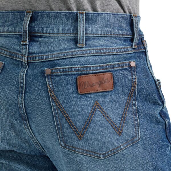 A modeled, close-up look at the detail on the back pocket of a pair of Wrangler Men's Retro Slim Bootcut Jeans.