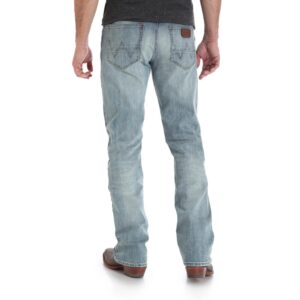 A modeled, rear-facing look at a pair of Wrangler Men's Retro Slim Fit Bootcut Jeans.