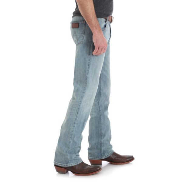 A modeled, right-side-facing look at a pair of Wrangler Men's Retro Slim Fit Bootcut Jeans.