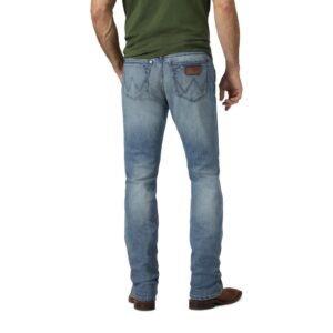 A modeled, rear-facing look at a pair of Wrangler Men's Retro Slim Fit Straight Leg Jeans.