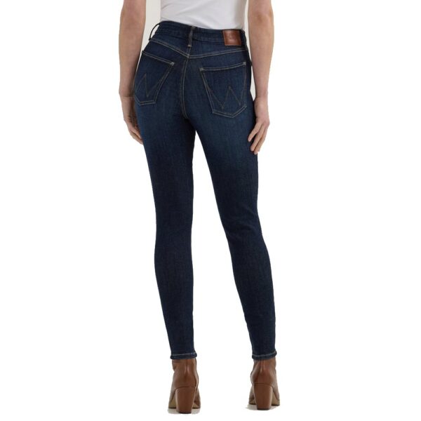 A modeled, rear-facing look at a pair of Wrangler Women's Bespoke High Rise Skinny Jeans.