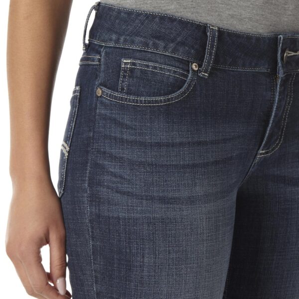 A modeled, close-up look at the detail on the front pocket of a pair of Wrangler Women's Essential Mid-Rise Bootcut Jeans.