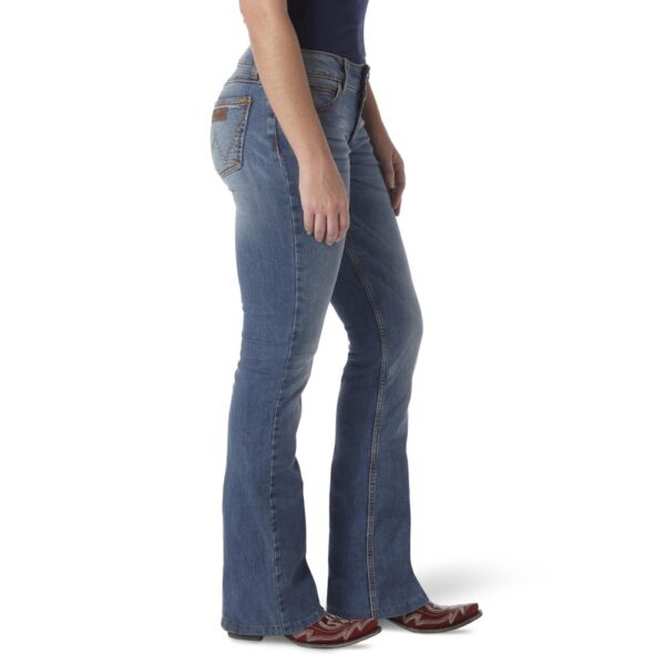 A modeled, right-side-facing look at a pair of Wrangler Women's Retro Mae Mid-Rise Bootcut Jeans.