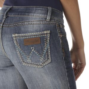 A modeled, close-up look at the detail on the back pocket of a pair of Wrangler Women's Retro Sadie Bootcut Jeans.